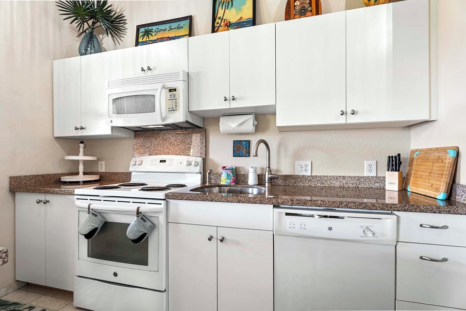 The upgraded kitchen offers full-size appliances, ample cabinetry, and everything needed to prepare island-inspired meals during your stay.