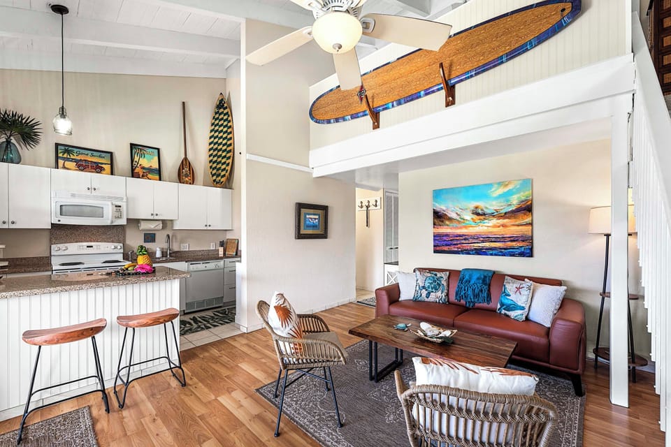 Relax in the bright living space where vaulted ceilings, coastal décor, and comfortable seating create the perfect gathering place after a day exploring Kona.