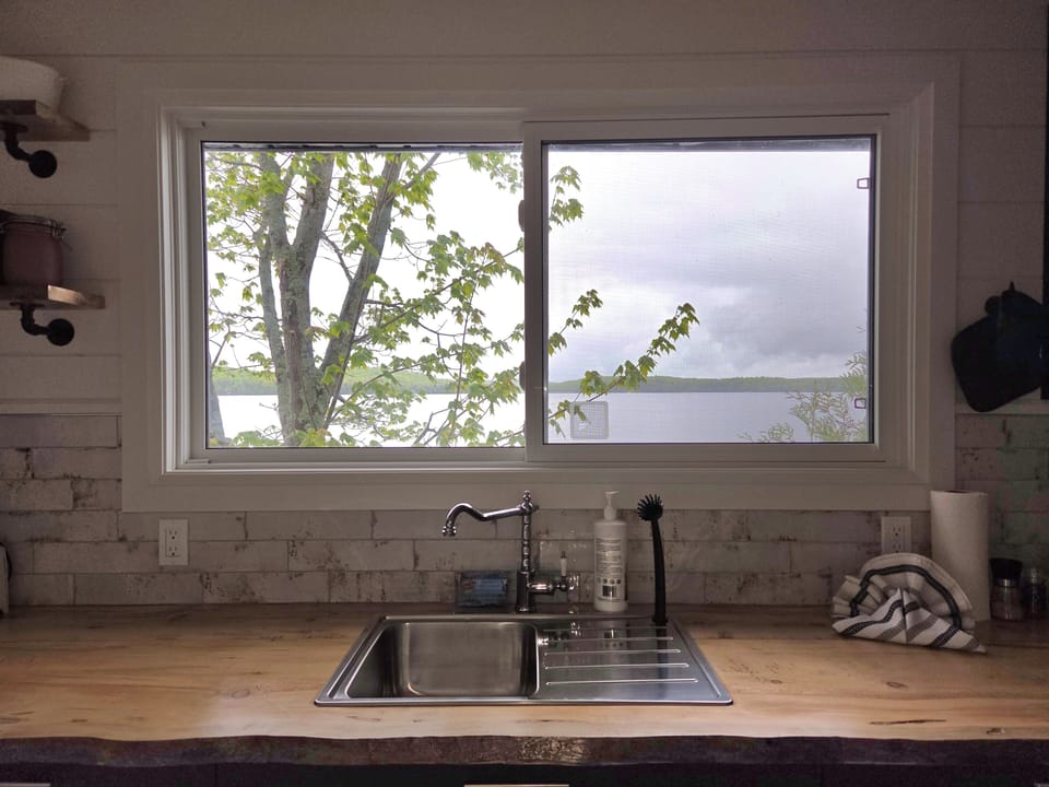 window over sink looking onto the lake