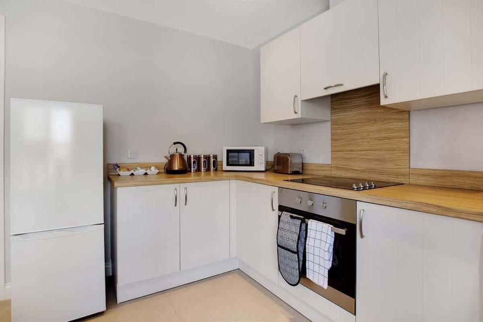 Kitchen equipped with all essentials, including a washer & dryer, oven, fridge and full cookware set.