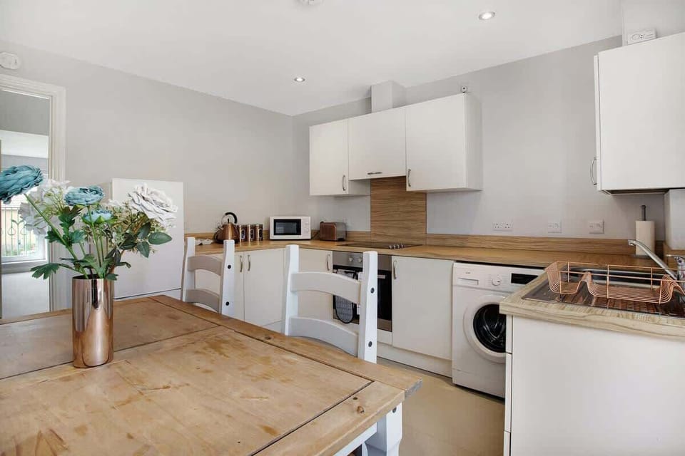 Kitchen equipped with all essentials, including a washer & dryer, oven, fridge and full cookware set.