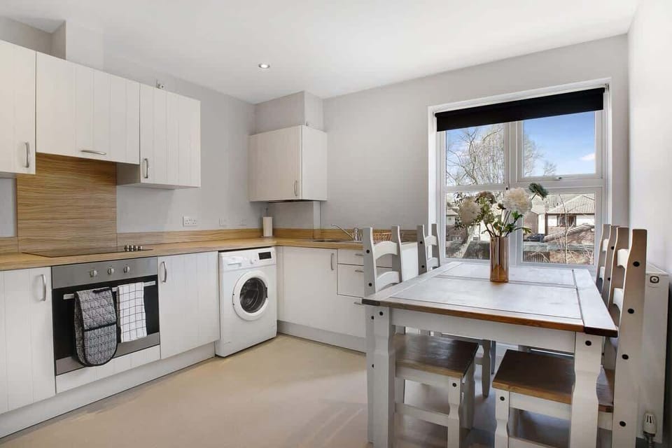 Kitchen equipped with all essentials, including a washer & dryer, oven, fridge and full cookware set.