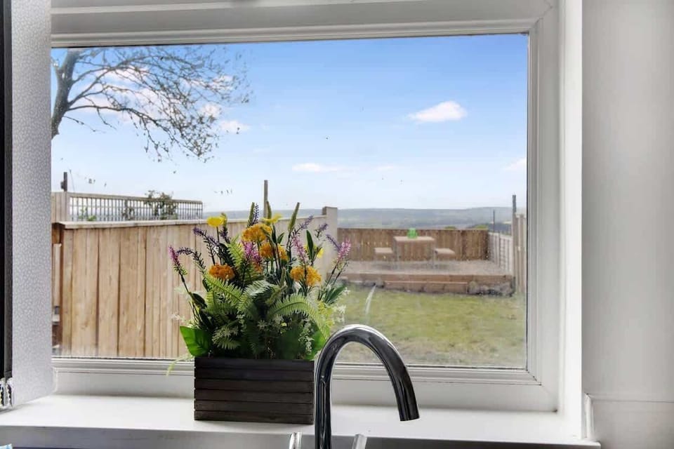 Scenic serenity meets practicality in our kitchen oasis, featuring a picturesque garden view from the window above the sink.