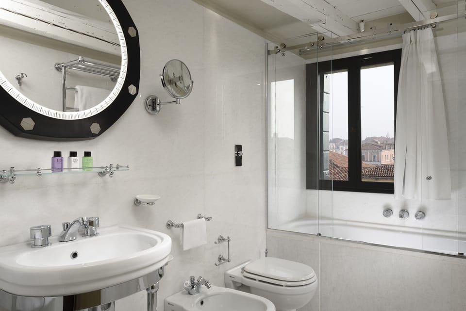 Designer toiletries, hair dryer, slippers, bidet