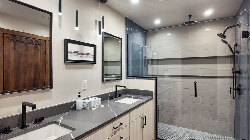 Full bath with glass shower and spacious vanity with modern style.