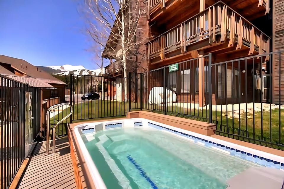 Outdoor hot tub with mountain views, perfect après-ski relaxation.