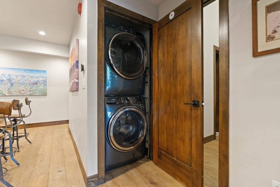 Laundry area with stacked washer and dryer for guest convenience.