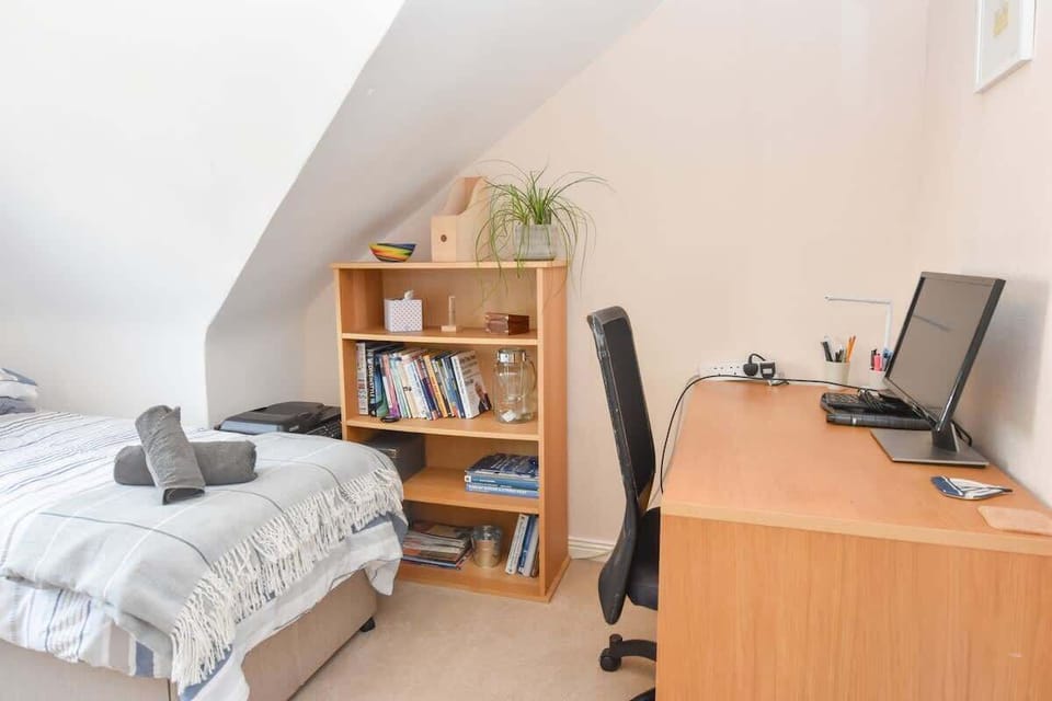 Top-floor bedroom with desk space, printer and wardrobe. 