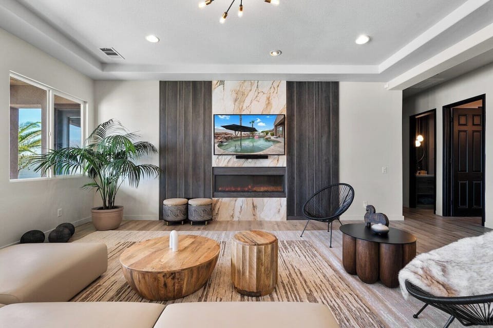 The custom fireplace paneling features the Fibonacci sequence and surrounds an entertainment system with a 65" smart TV, Sonos sound system, and custom electric fireplace.