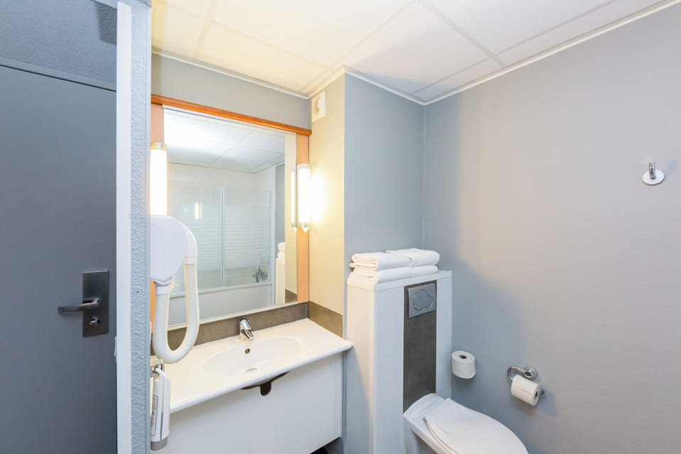 Standard Room, Multiple Beds | Bathroom | Eco-friendly toiletries, hair dryer (on request), towels
