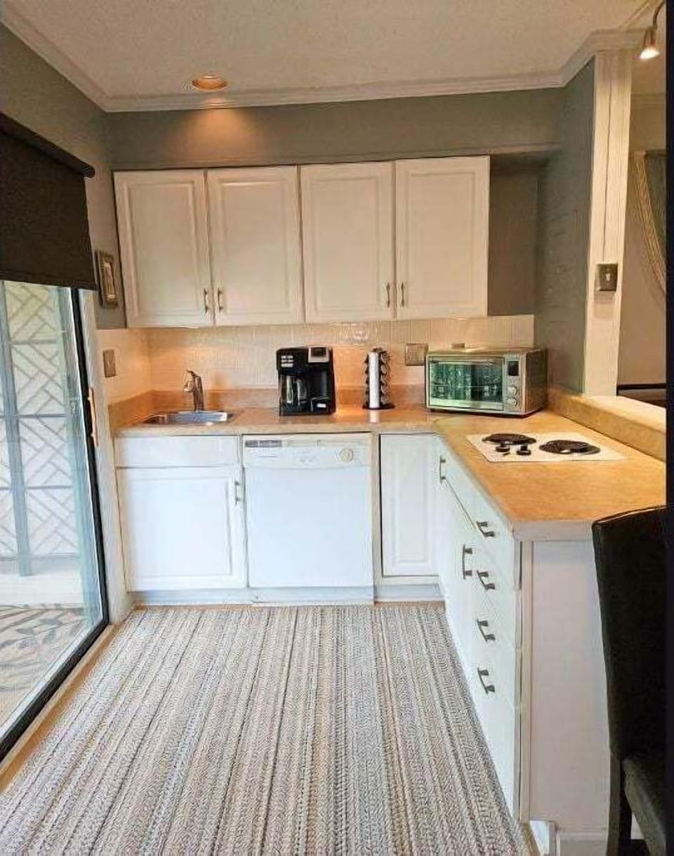 Kitchen includes Dishwasher and coffee maker, stove top,