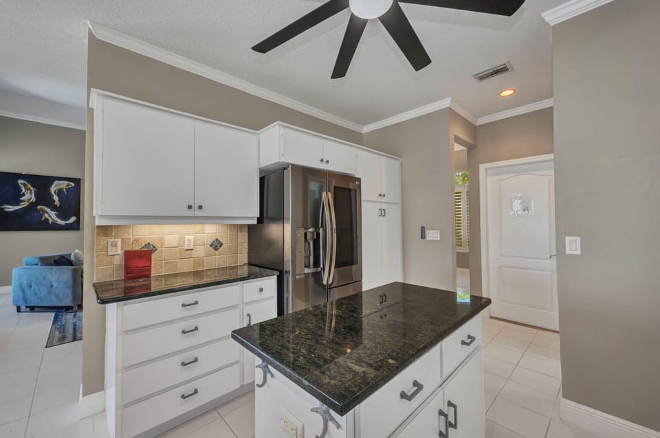 MODERN APPLIANCES INCLUDE LARGE STAINLESS REFRIGERATOR.