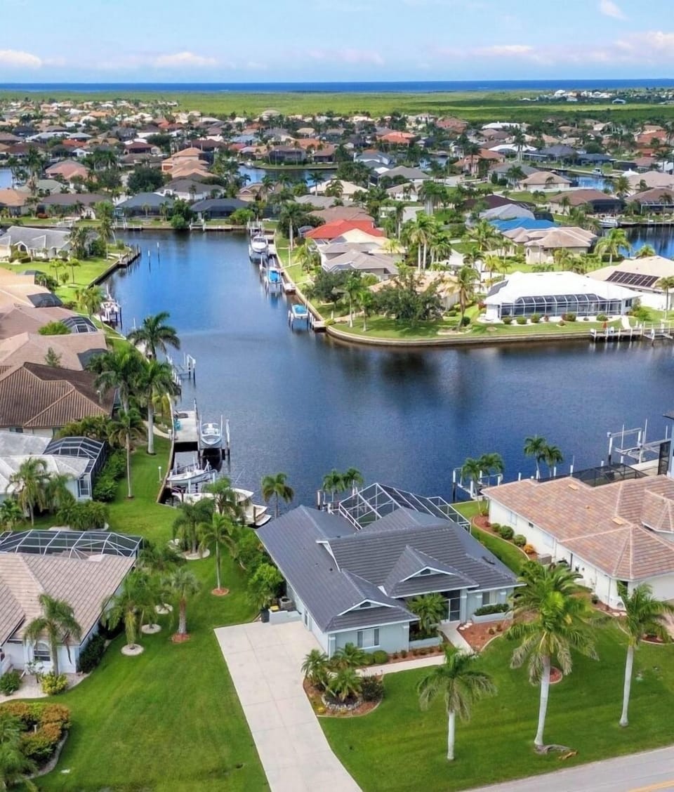 INCREDIBLE HOME IS SURROUNDED BY WATER WITH FISH JUMPING