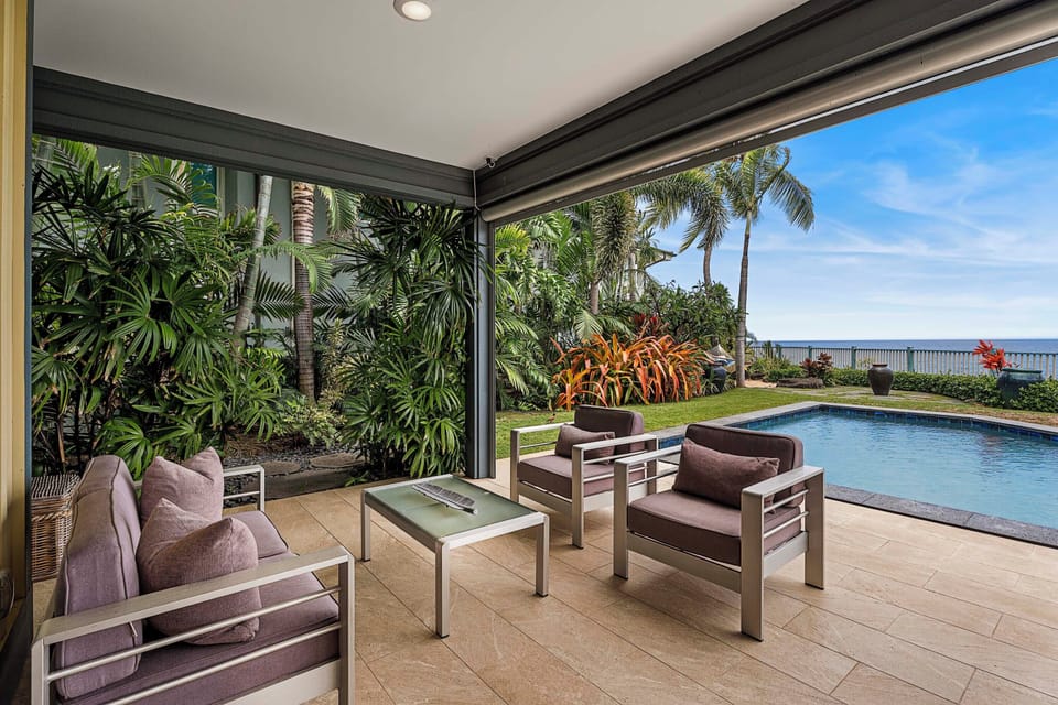 Garden-view seating area beside the pool, perfect for relaxing or conversation