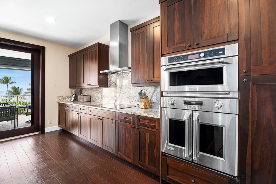 Fully equipped kitchen with double ovens, granite counters, and ample storage