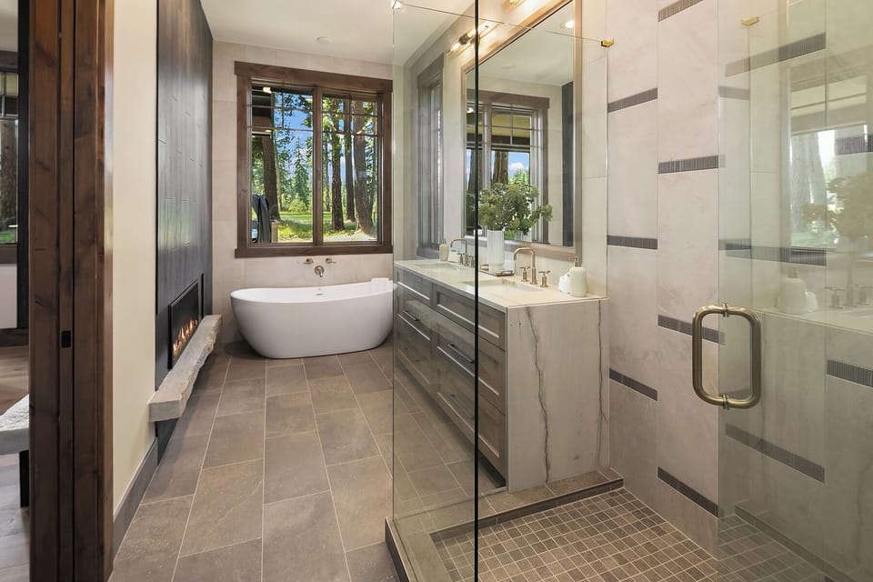 Reve Spa Lodge: - Main floor master bath with a soaking tub, walk-in shower, and dual sinks.