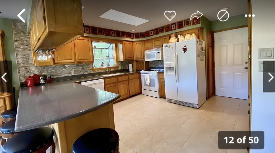 Spacious kitchen fully stocked with glasses, dishes, cookware and more. 