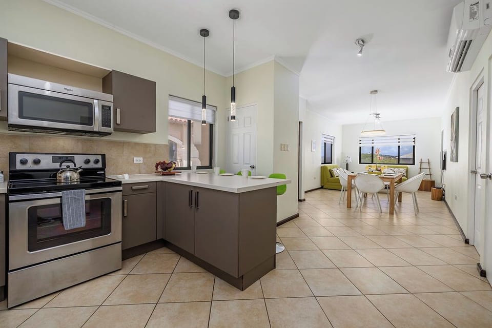 Open-concept living with a seamless flow from kitchen to dining and lounge—bright, spacious, and perfect for gathering or relaxing after a day in Aruba.