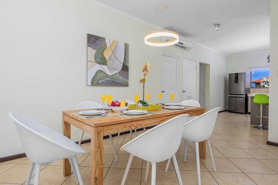 Comfortable dining setup with seating for 6 at the table, plus 3 additional seats at the kitchen island—perfect for gathering and entertaining.