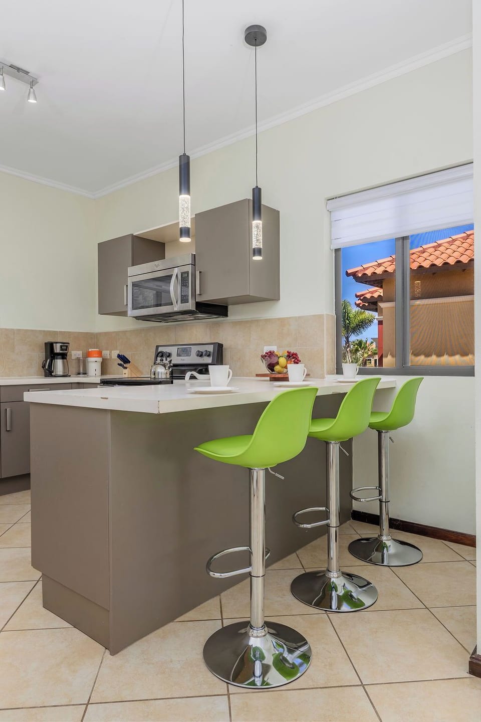 Modern kitchen with clean finishes, stainless steel appliances, and a bright breakfast bar—perfect for casual dining or morning coffee before heading out to explore Aruba.