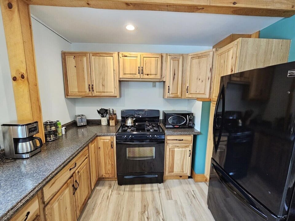 Fully stocked kitchen. Drip coffee pot, french press, toaster, microwave, and spices.