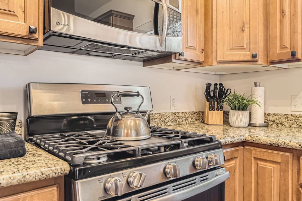 Cook like a pro in this gourmet kitchen featuring granite countertops, stainless steel appliances, and custom wood cabinetry