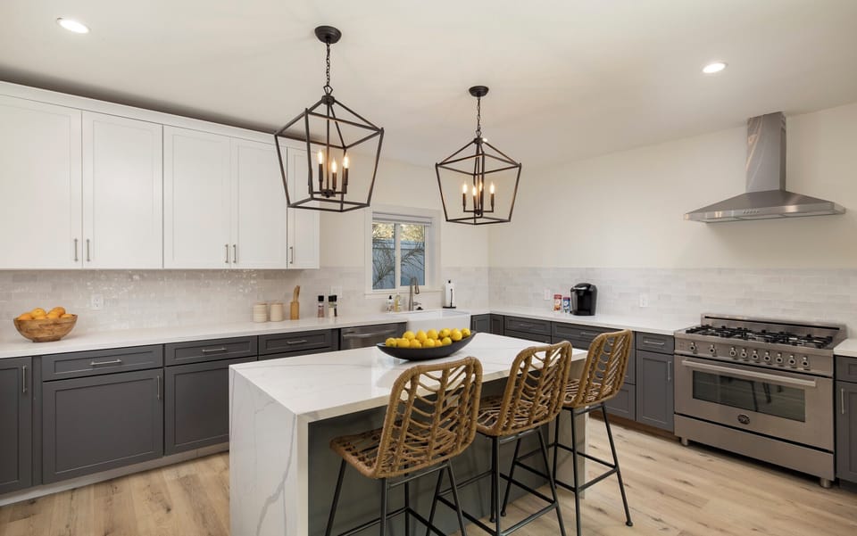 Newly remodeled kitchen with quartz countertops, farmhouse sink, large island