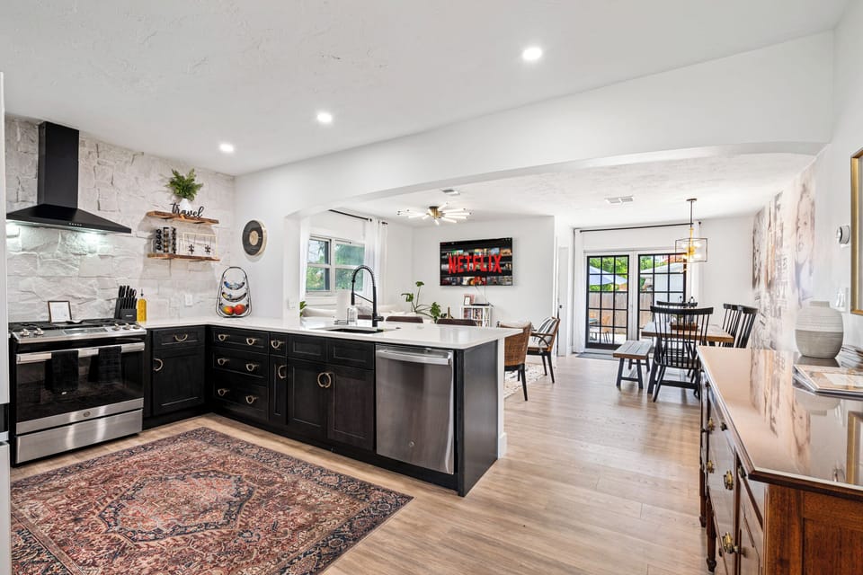 The open kitchen flows into dining and lounge — perfect for gathering.