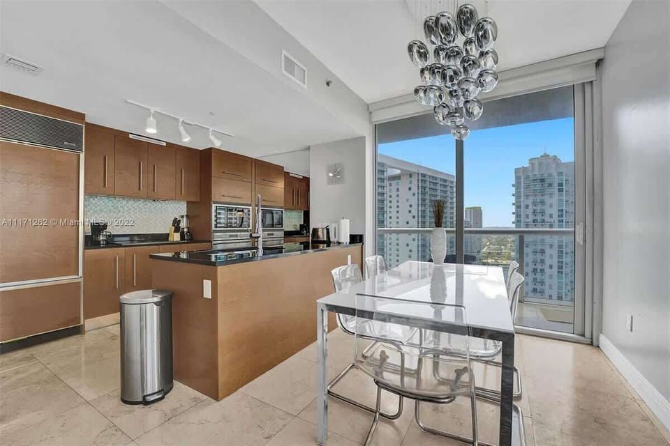 Sleep soundly in this serene bedroom with floor-to-ceiling windows and urban views—ideal for romantic getaways.


