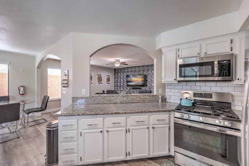 Open kitchen with granite, stainless appliances, and bar seating