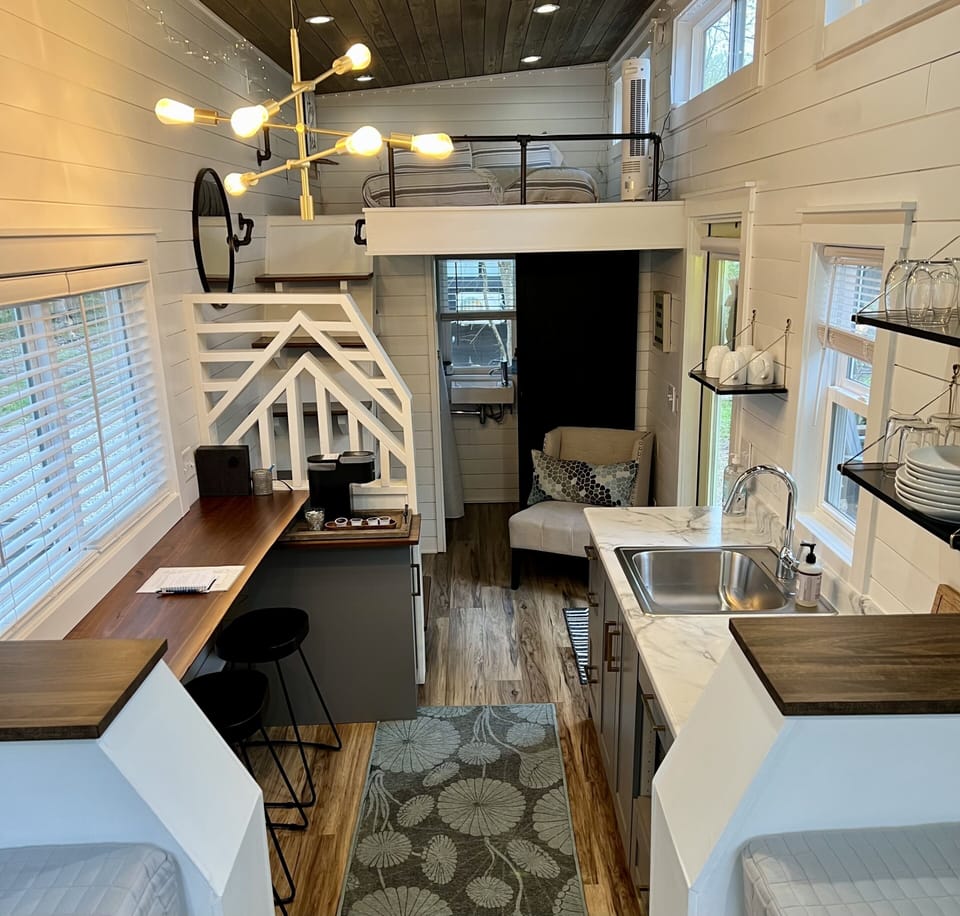 This view from the seating area shows the loft with bathroom underneath.  