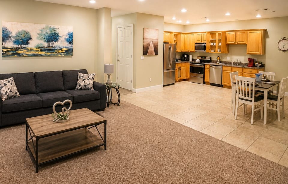 Bright open living space with full kitchen, dining area, and cozy seating