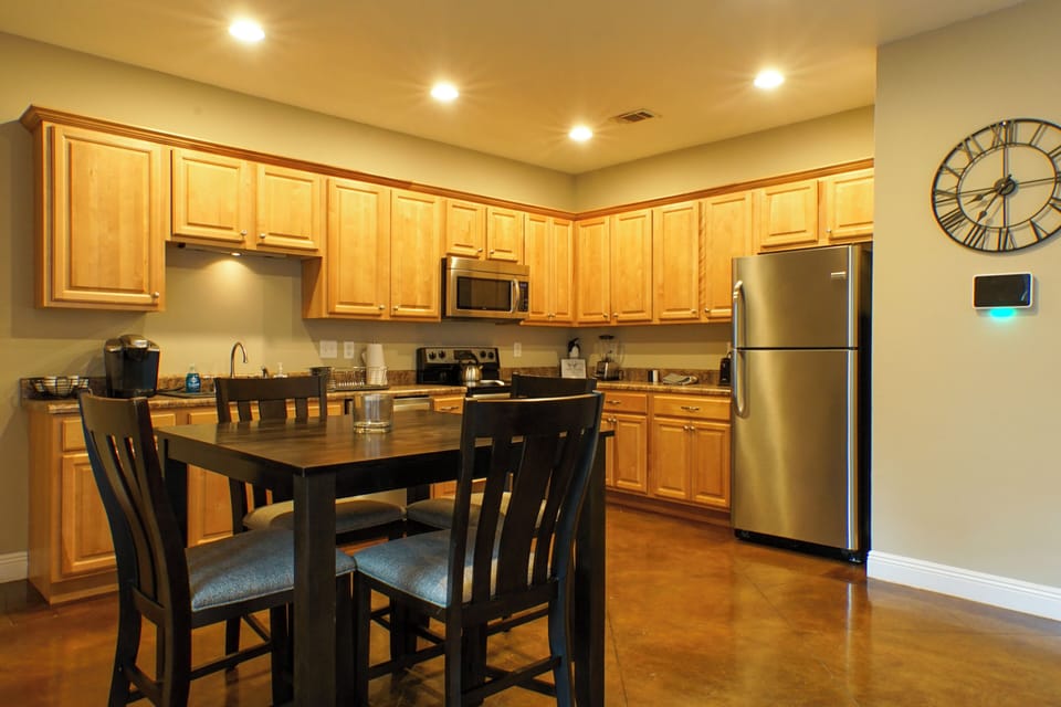 Spacious eat-in kitchen with stainless appliances and seating for 4