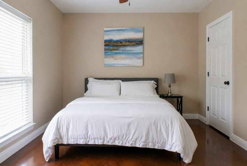 Bright, cozy bedroom with crisp linens and warm, minimalist style