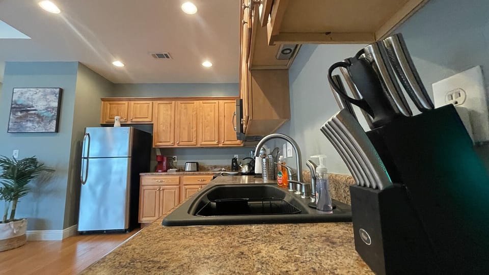 Bright, fully equipped kitchen with ample counter space and warm finishes