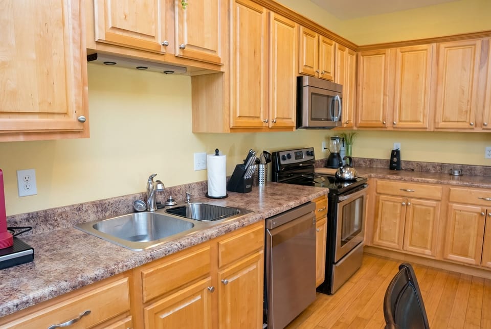 Bright full kitchen with stainless appliances and abundant counter space