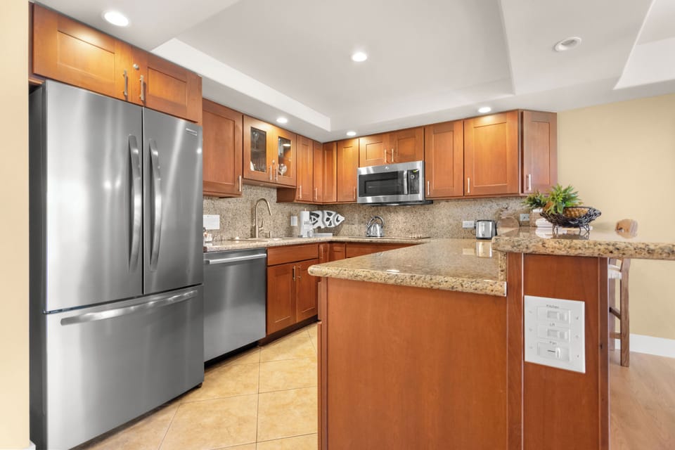 Your gourmet kitchen features granite countertops, warm wood cabinets, and premium stainless steel appliances for effortless meal prep.