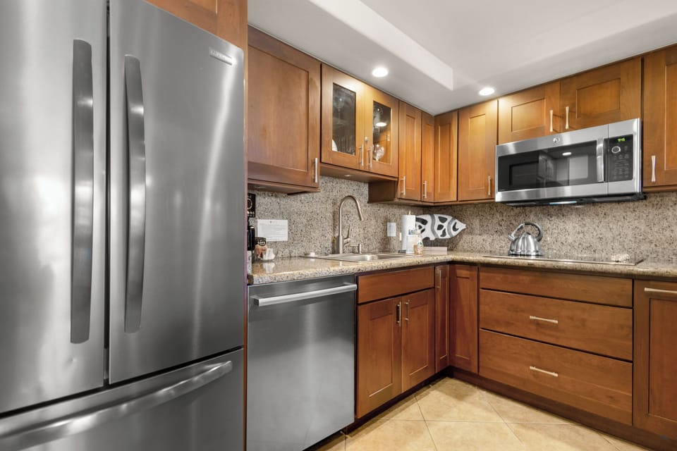 Your fully equipped kitchen features stainless steel appliances and warm wood cabinetry, perfect for preparing meals during your stay.