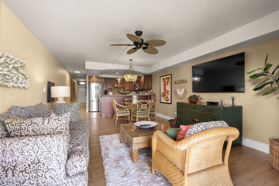 Unwind in your tropical-inspired living space with comfortable seating and an open layout that flows seamlessly into the fully-equipped kitchen.