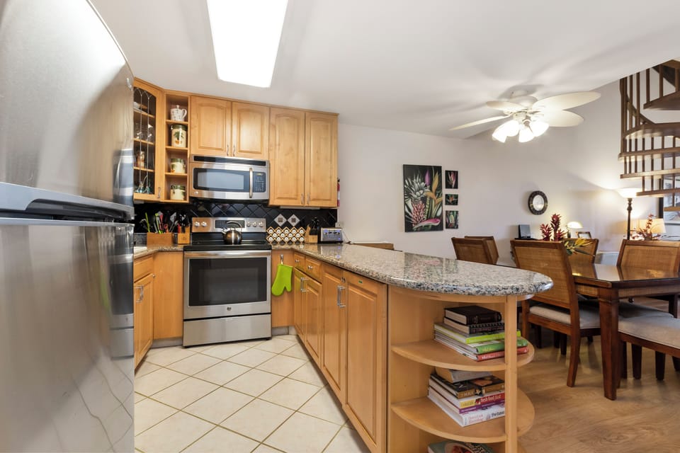 Step into your fully equipped kitchen with granite counters, stainless appliances, and a breakfast bar that flows into the cozy dining area—perfect for home-cooked meals and memorable evenings together.
