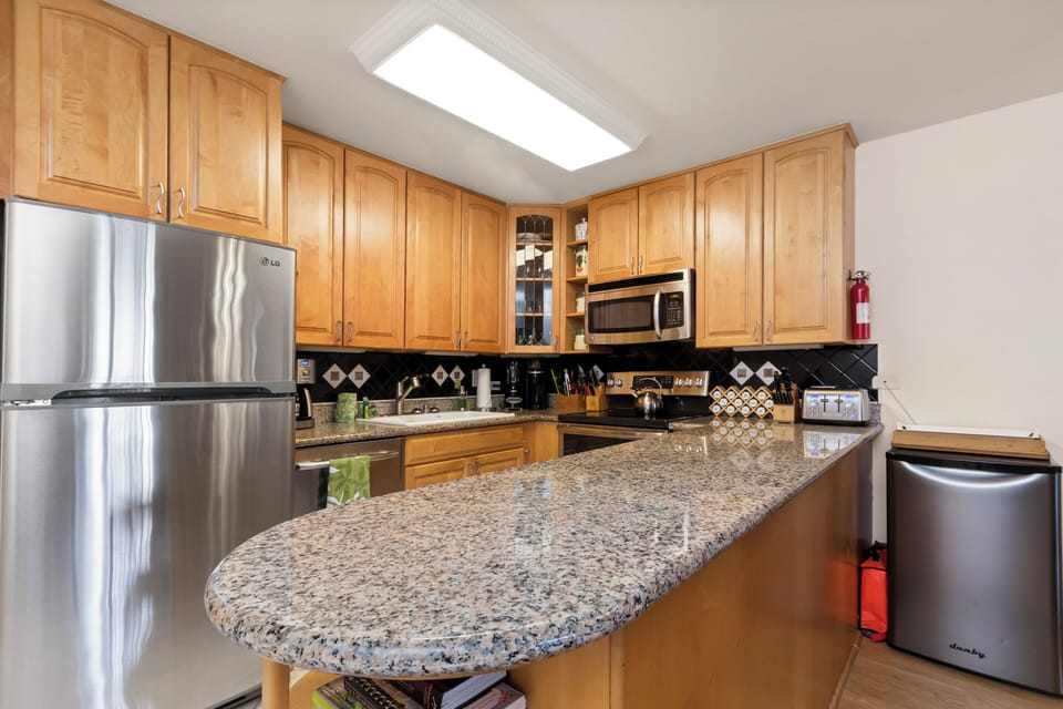 Picture yourself preparing meals at this spacious granite island, bathed in natural skylight. Stainless steel appliances and abundant cabinetry make your culinary adventures effortless and enjoyable.