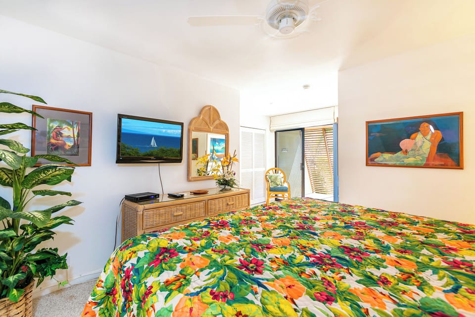 Drift off in your bright, cheerful bedroom with tropical flair. Colorful artwork, a flat-screen TV, and natural light make your space feel like a sunny island retreat.
