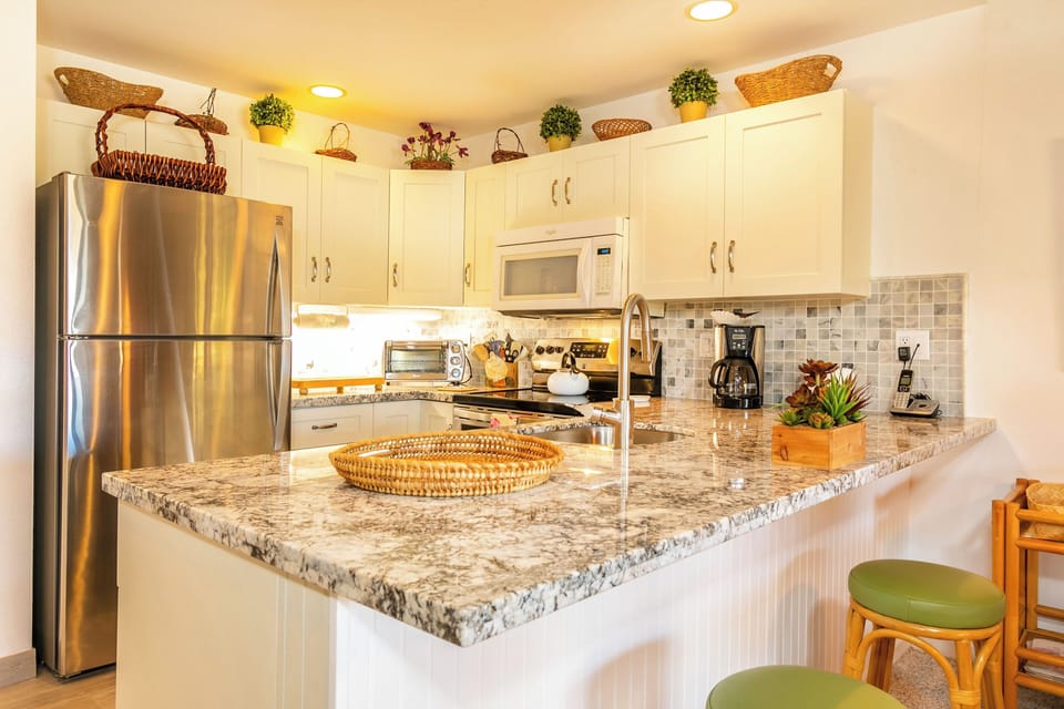 Whip up your favorite meals in this bright, fully-equipped kitchen with modern appliances, granite countertops, and cheerful touches that make cooking feel like home.