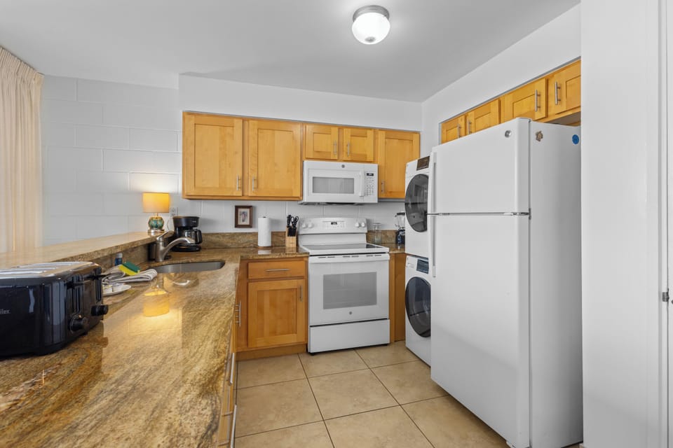 Your fully-equipped kitchen features granite countertops, modern appliances, and in-unit laundry—everything you need to feel right at home during your stay.