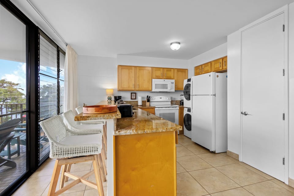 Your fully equipped kitchen features granite countertops, modern appliances, and in-unit laundry—everything you need for a comfortable, convenient stay.