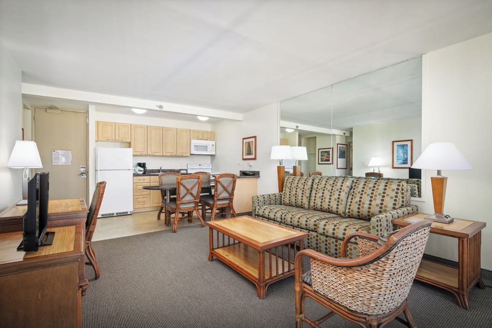 Your open-concept suite features a fully equipped kitchen, cozy living area, and comfortable dining space—perfect for relaxing after a day of exploring. Warm wood tones and ample natural light create a welcoming home base.