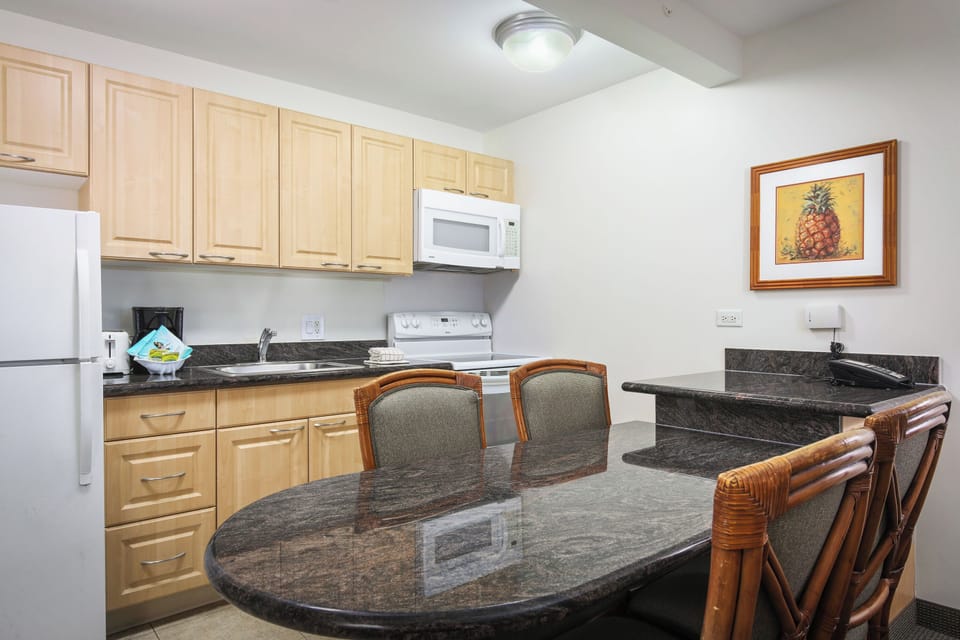 Your fully equipped kitchen offers everything you need to prepare meals at your own pace, with granite countertops, modern appliances, and comfortable seating for shared breakfasts or late-night snacks.