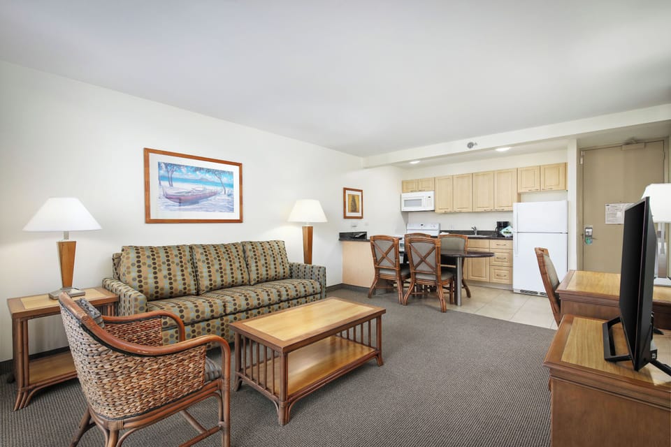 Settle into your spacious suite where coastal artwork sets the tone, a comfy sofa invites relaxation, and your full kitchen makes it easy to enjoy meals just the way you like them.