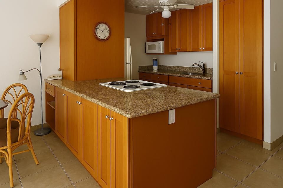 Your fully equipped kitchen features a convenient center island with a cooktop, granite countertops, and warm wood cabinetry—perfect for preparing your favorite meals in comfort.