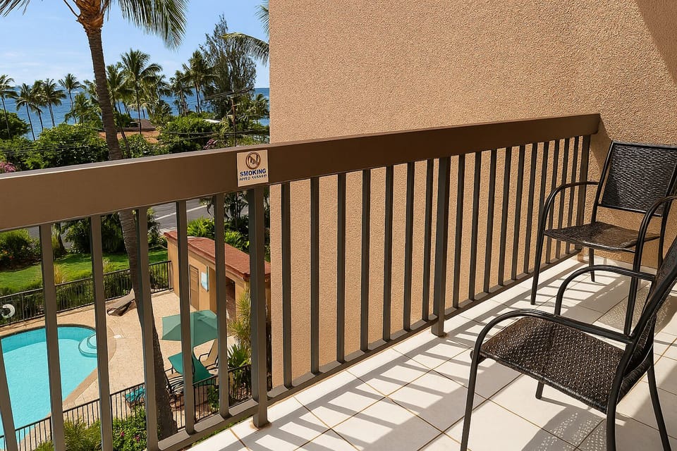 Settle into your private balcony and soak up stunning views of swaying palms, sparkling blue ocean, and the inviting pool below—your tropical paradise awaits.